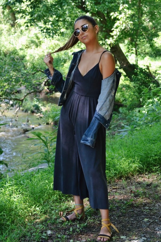 Full body shot of girl wearing culotte jumpsuit with jean jacket