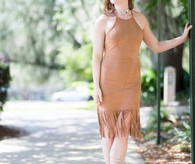 Girl posing in a suede dress dress